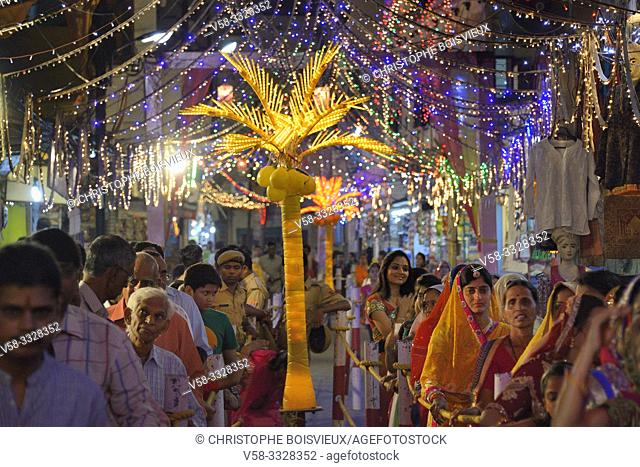 India, Rajasthan, Udaipur, Diwali festival, Men and women queing before Lakshmi temple