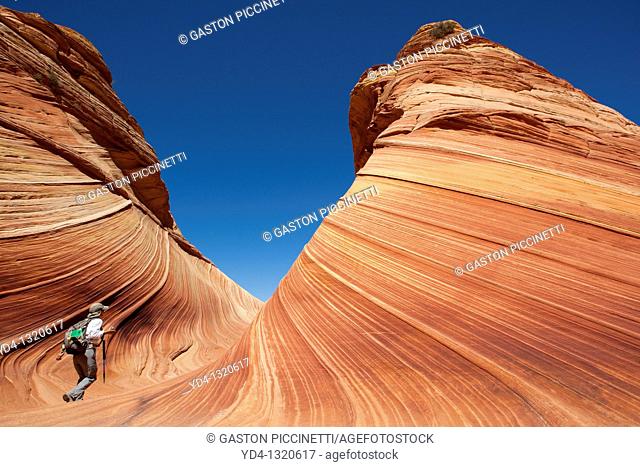 A woman in the Wave, Vermilion North Coyote Buttes, Paria Canyon-Vermilion Cliffs Wilderness, Vermilion National Monument, Arizona, USA