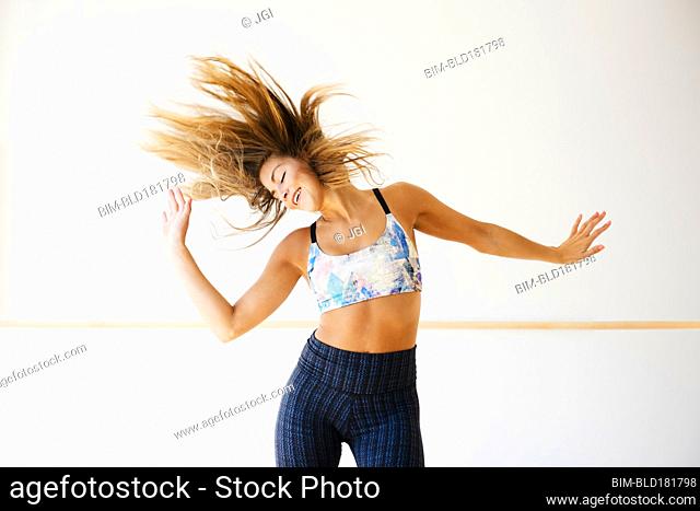 Mixed race dancer practicing in studio