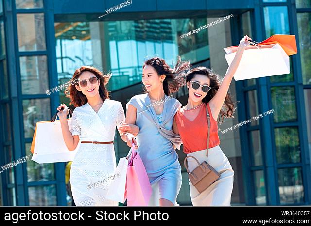 Young girlfriends go shopping shopping