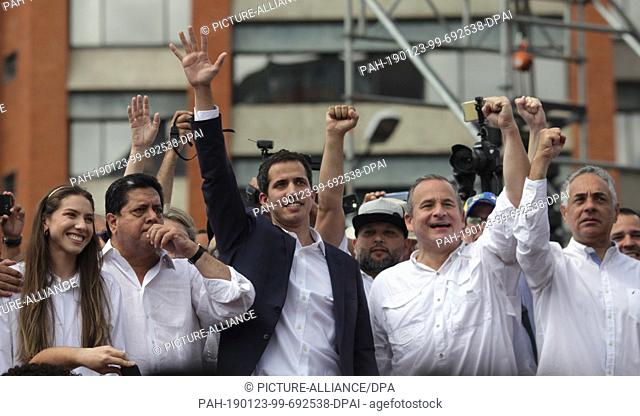 23 January 2019, Venezuela, Caracas: Juan Guaido, president of the deprived parliament in Venezuela, waves to supporters after declaring himself head of state