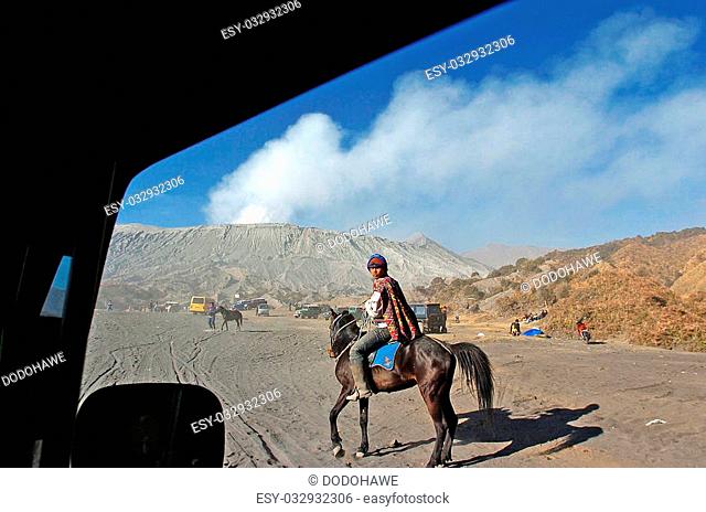 Tenggerr tribal sit a horse around the crater of Bromo, East Java, Indonesia