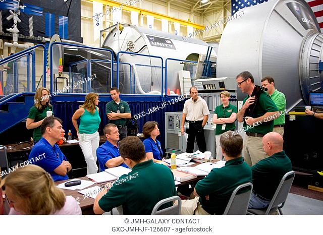 Expedition 2526 and 2627 crew members participate in an emergency scenario training session in the Space Vehicle Mock-up Facility at NASA's Johnson Space Center