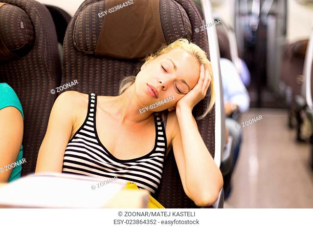 Lady traveling napping on a train