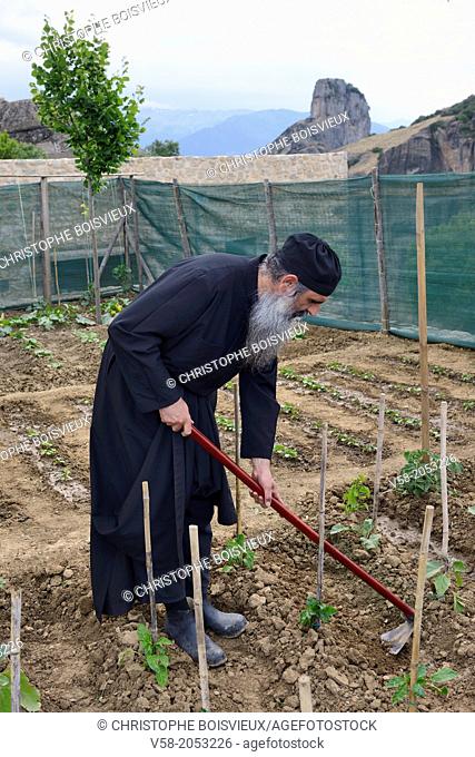 Greece, Thessaly, Meteora, World Heritage Site, Agia Trias (Holy Trinity) monastery, Father Dometios at work in his vegetable garden