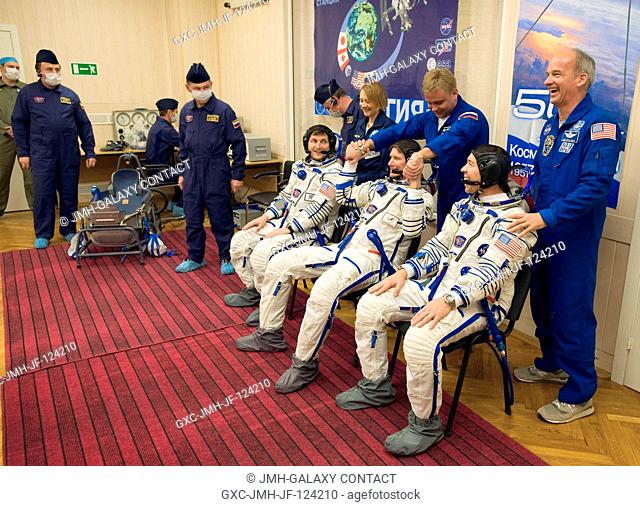 Spaceflight Participant Charles Simonyi, seated left, Expedition 19 Commander Gennady I. Padalka, seated center, Flight Engineer Michael R