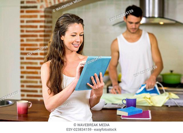 Woman using tablet in kitchen