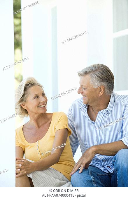 Mature couple sitting together outdoors