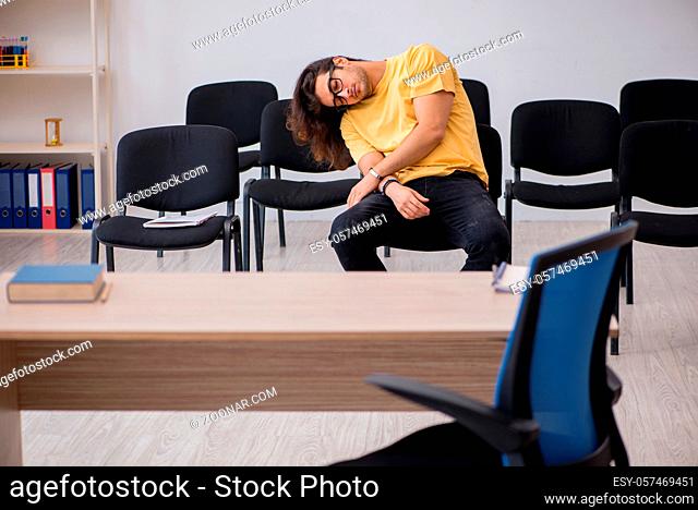 Young student waiting for teacher in the classroom