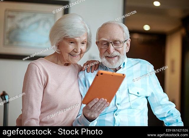Excitement. Senior man and woman watching something online and looking excited