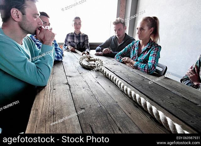 Hipster business teamwork brainstorming planning meeting concept, people sitting around the table with rope node