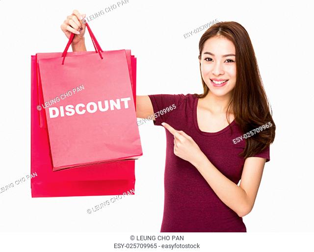 Woman finger point to shopping bag and showing a word discount