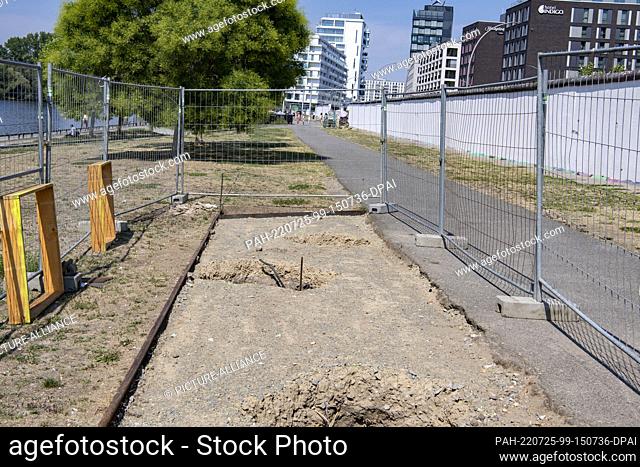 25 July 2022, Berlin: A construction site on the East Side Gallery is fenced off. Work on the ""New Open-Air Exhibition on the East Side"" is expected to...