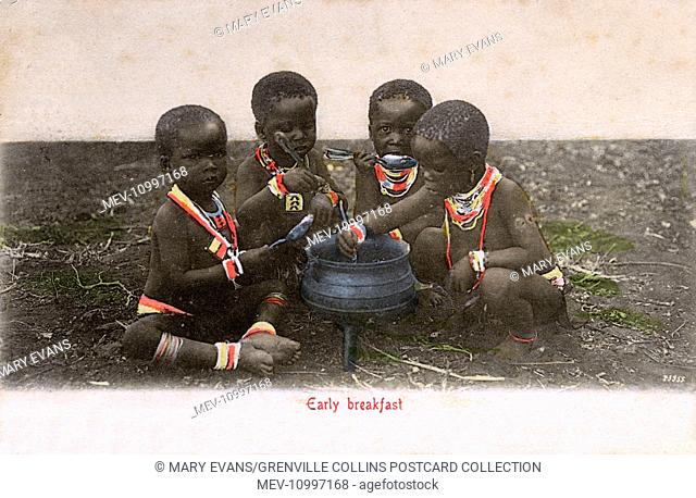 Four young Zulu children enjoy an 'early breakfast'