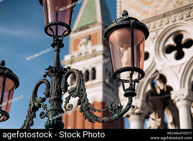 Italy, Venice, Ornate street light with St. Marks campanile in background