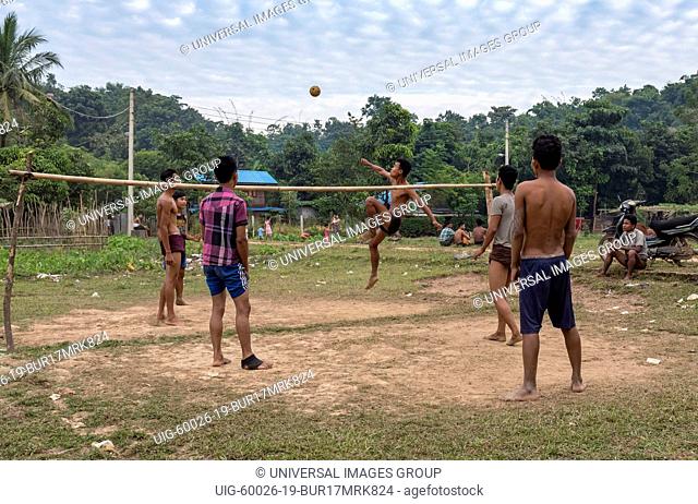 Villagers play a game of Sepak Takraw in Mrauk U, Burma, Myanmar