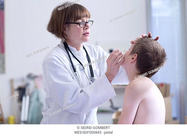 Doctor examining boy in medical practice