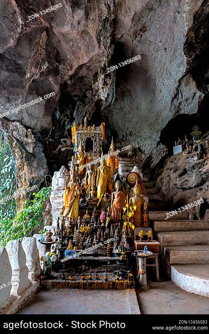 Hundreds of old and faded Buddha statues inside the Tham Ting Cave at the famous Pak Ou Caves near Luang Prabang in Laos