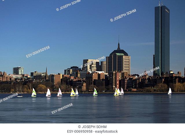 Boston Skyline, sail boats and Prudential Bld. in winter on half frozen Charles River, Massachusetts, USA