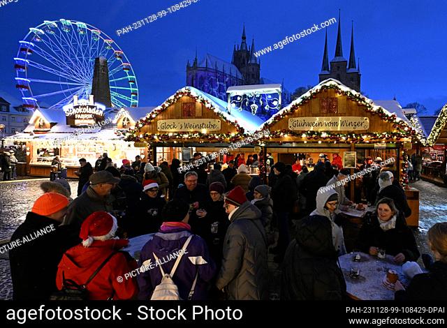 28 November 2023, Thuringia, Erfurt: Lights shine at Erfurt's Christmas market on the opening day. Against the atmospheric backdrop of the cathedral and St