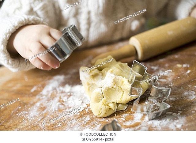 Child cutting out biscuits