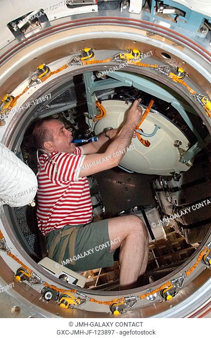 Russian cosmonaut Pavel Vinogradov, Expedition 36 commander, opens the hatch in the Zvezda Service Module transfer tunnelATV vestibule of the International...
