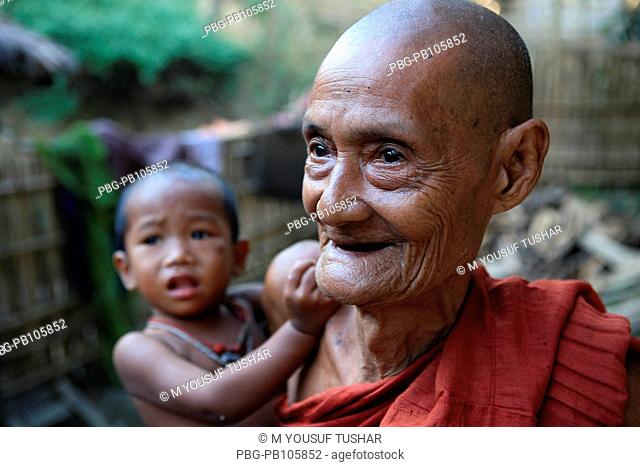 An ethnic old man holding his grand child at Tindu Bandarban, Bangladesh December 2009
