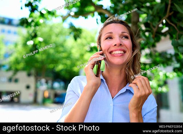 Happy woman talking through smart phone
