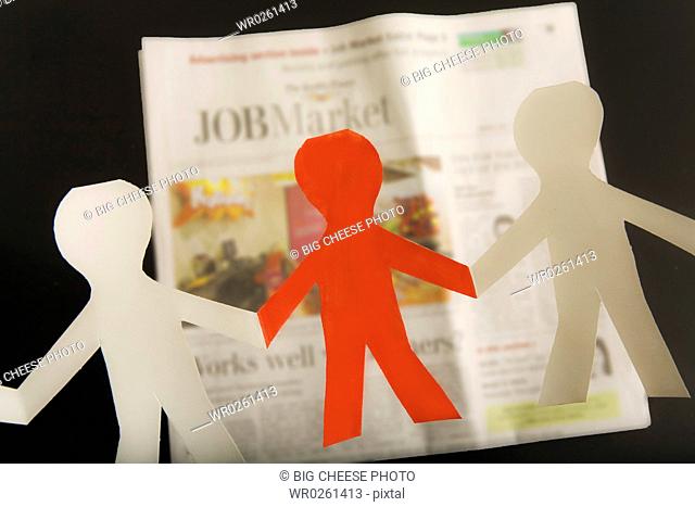 Paper dolls and employment section of newspaper
