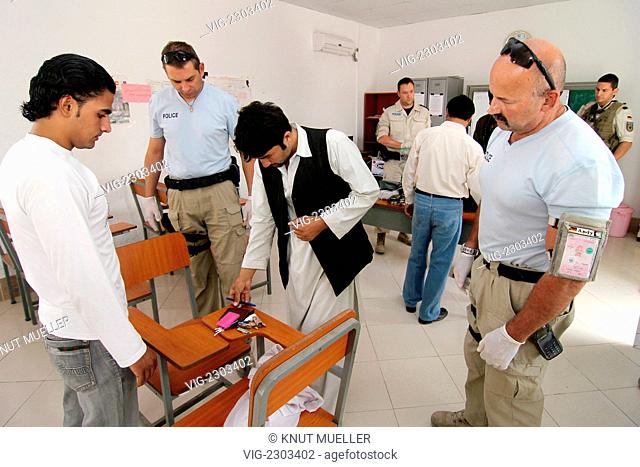 German policemen examine Afghan police applicants in the German Police Training Centre, PTC. - Mazar-e-Sharif, Kunduz, AFGHANISTAN, 08/09/2010