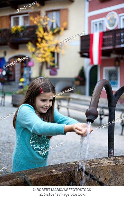 Girl playing with water. Hallstatt Austria