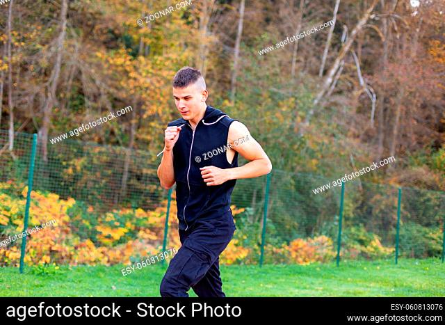 Young man jogging in the morning outdoor in nature