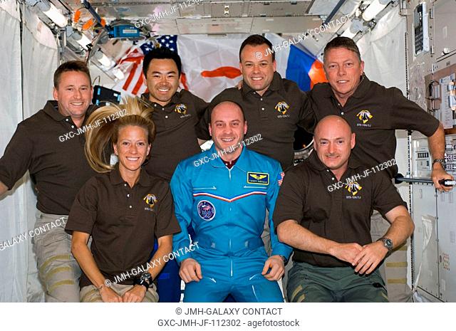 STS-124 crewmembers pose for a portrait following a joint news conference with the Expedition 17 crewmembers from the Kibo Japanese Pressurized Module of the...