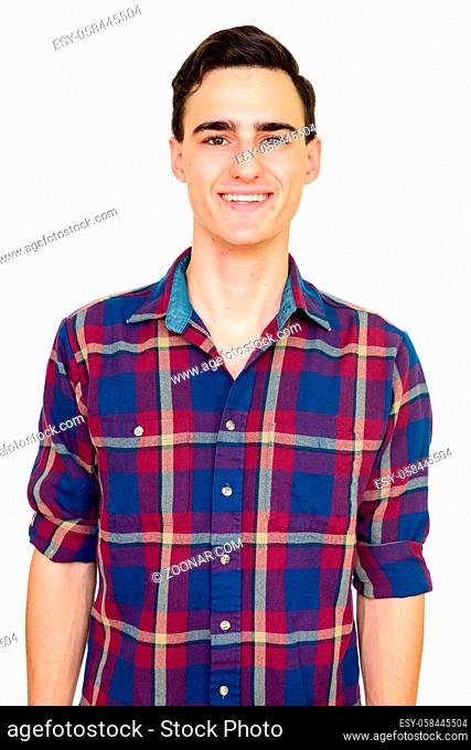 Studio shot of young handsome hipster man isolated against white background