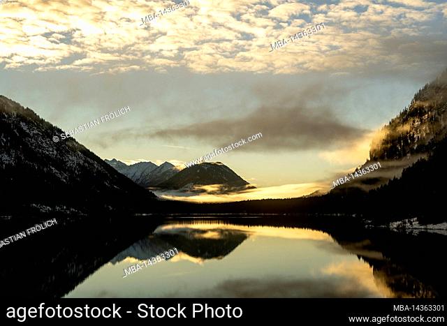 Fog and cloud atmosphere at the Sylvensteinspeicher, a lake / reservoir in the Bavarian Alps on the edge of the Karwendel