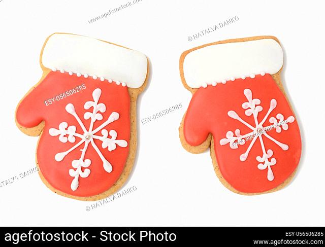 baked gingerbread in the shape of a mitten and covered with red icing, a classic Christmas dessert