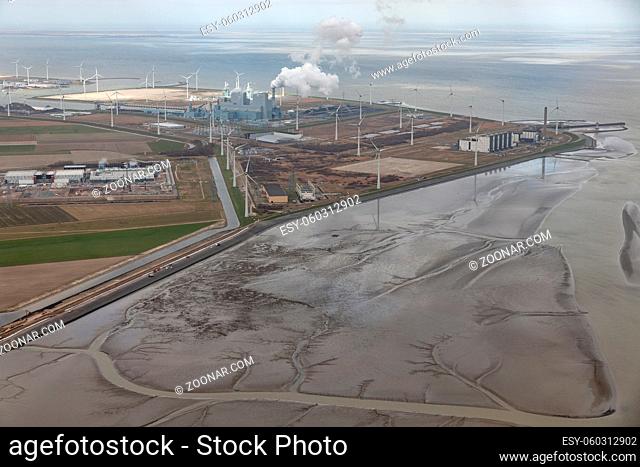 Aerial view Dutch Eemshaven near Wadden sea with wind turbines and coal powered electricity plant