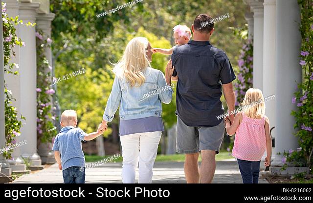 Young caucasian family taking A walk in the park