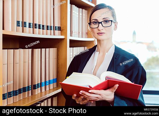 Lawyer working on a difficult case reading in the library of law firm