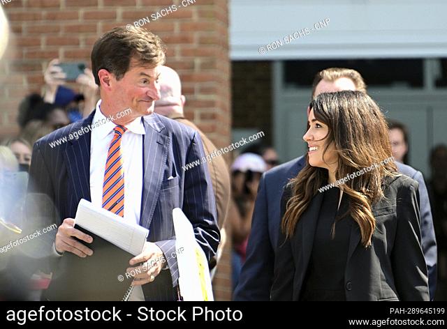 Johnny Depp lawyers Benjamin G. Chew, left, and Camille Vasquez, right, look at one another as they walk to the microphones to make statements outside the...