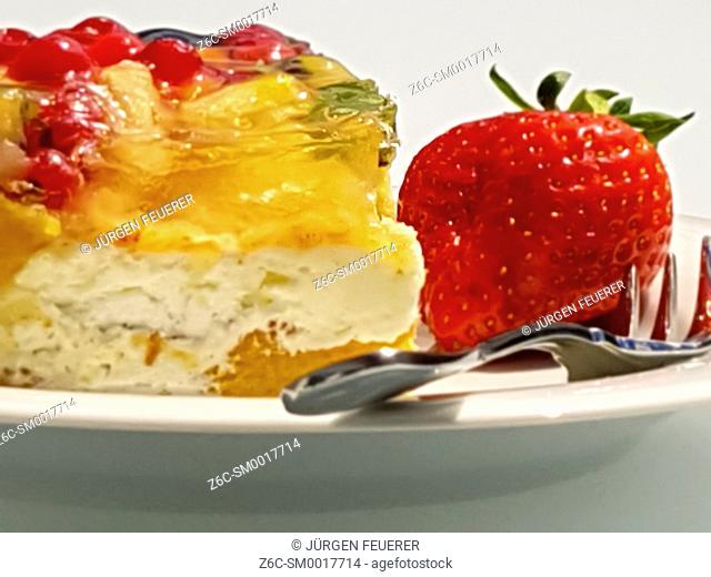 piece of colorful fruit cake with layers and strawberry