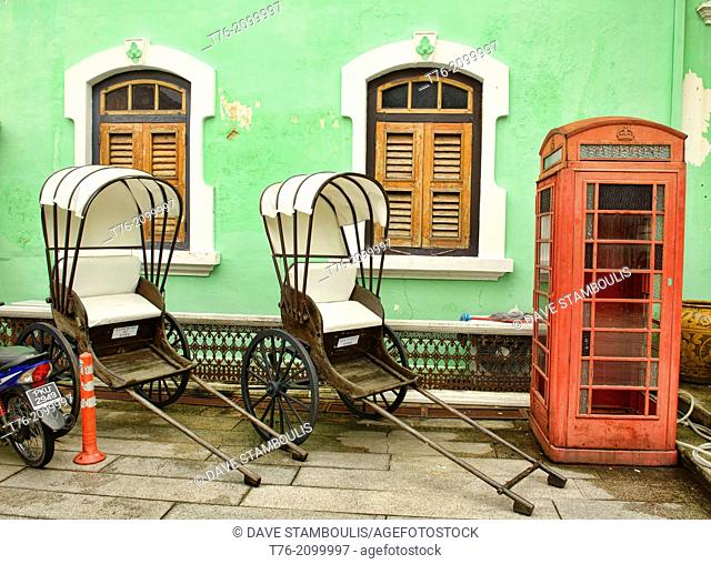 trishaws and phone booth at the Pinang Peranakan Mansion in Georgetown, Penang, Malaysia