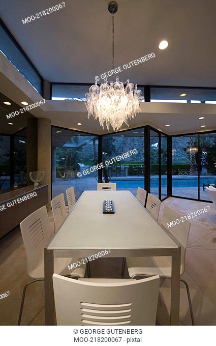 Dining table of Palm Springs home lit with glass chandelier