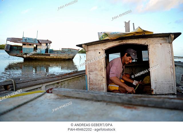 A man works on a boat that lies on the shore near Porto Seguro in Brazil, 09 June 2014. The German national soccer team stays in a hotel near Porto Seguro...
