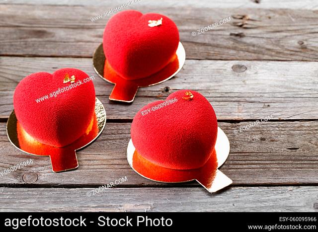 Red macaroons desserts wooden background. dessert for breakfast on Valentine's Day