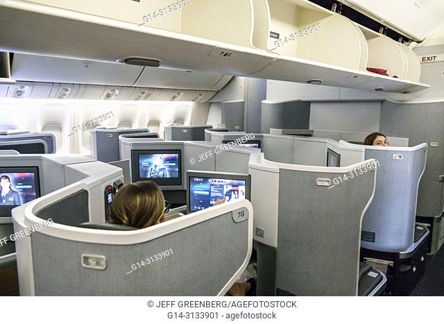 Florida, Miami, International Airport MIA, American onboard Airlines flight 56 business class seat seating cabin inside, seatback screens