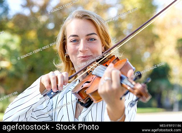 Violinist playing violin at park