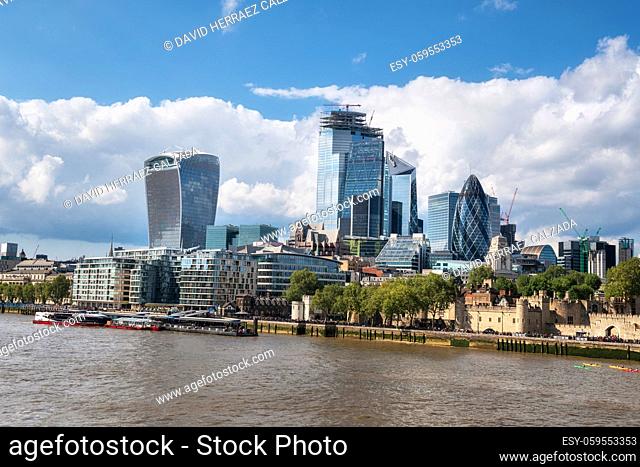 Thames river and London city financial district skyscrapers on a sunny day