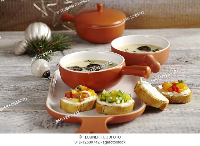 Cream of Parmesan soup with candied walnut, and baguette topped with tomato and cucumber tartare