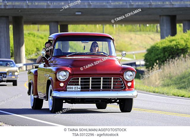 Salo, Finland. May 18, 2019. Woman drives a mid-1950s Chevy pickup, the male passenger is photographing on Salon Maisema Cruising 2019